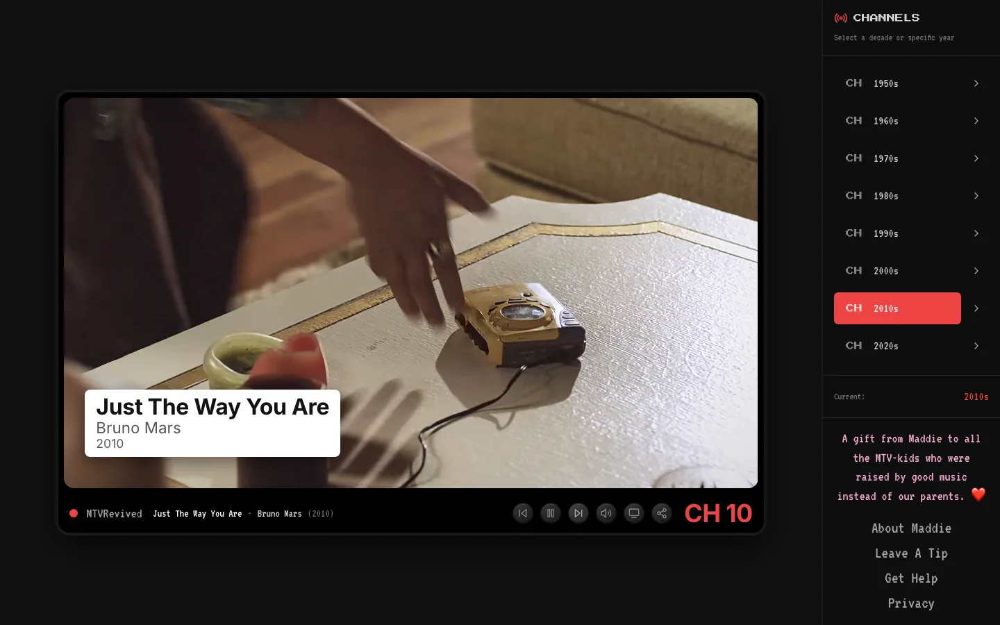 The 2010s channel: a thin black bezel around the picture, playing Just The Way You Are by Bruno Mars, with a plain white caption card.