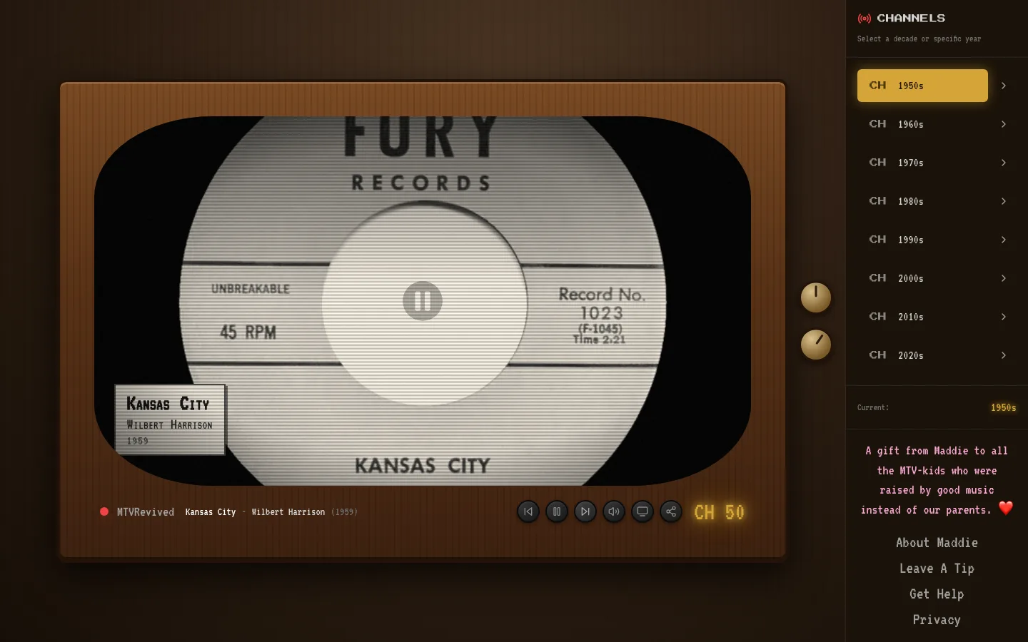 The 1950s channel: a mahogany console television with a rounded, almost square screen, playing Kansas City by Wilbert Harrison in black and white. A caption card in the corner gives the song, the artist and the year 1959.